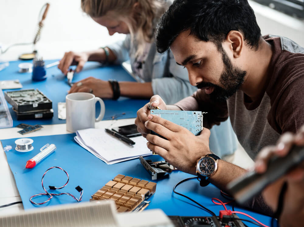 Electrical Technicians workingon electronics parts.jpg